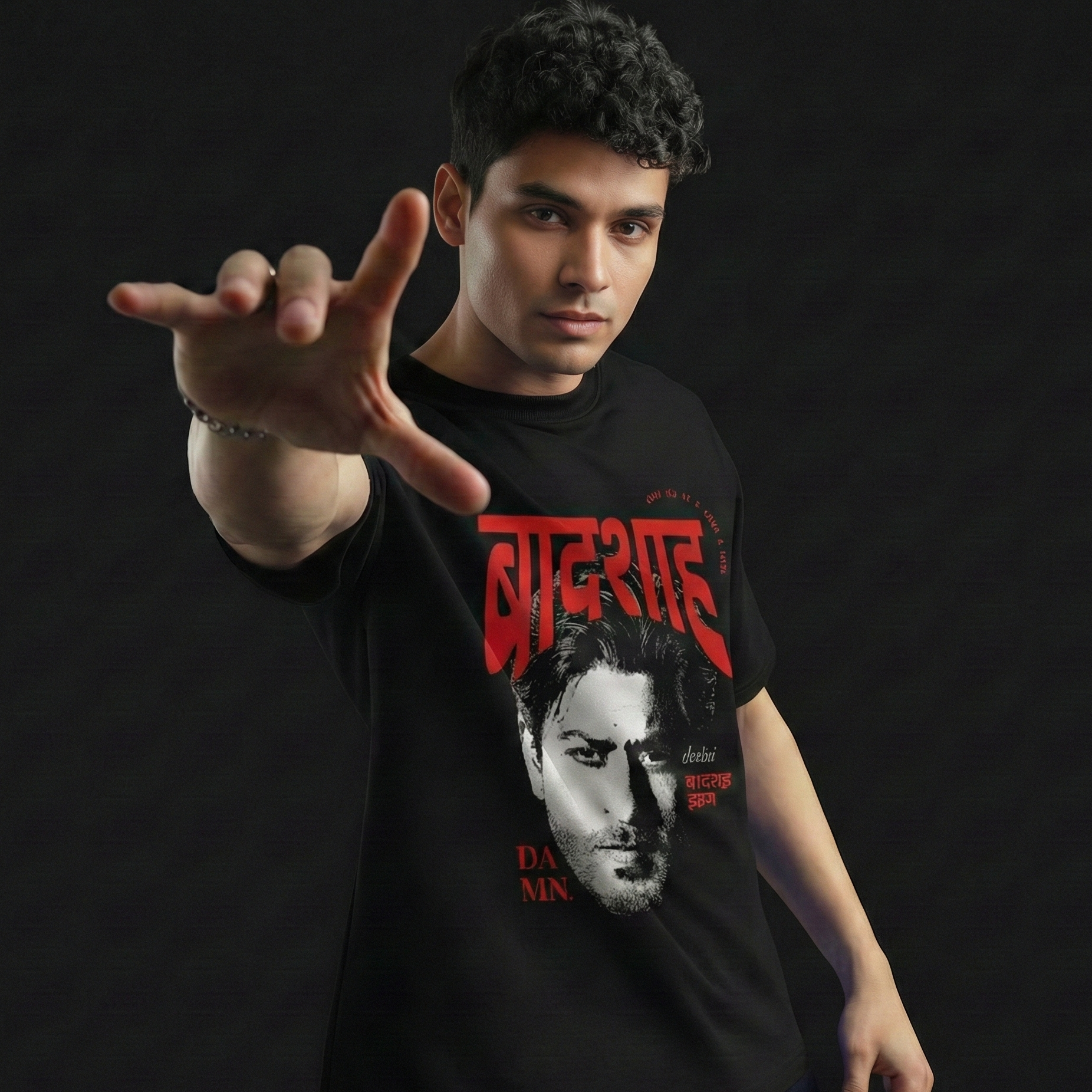 Person wearing a black t-shirt with a graphic design on a dark background